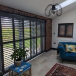Anthracite Tracked Shutters Over Bi Folds in Chester