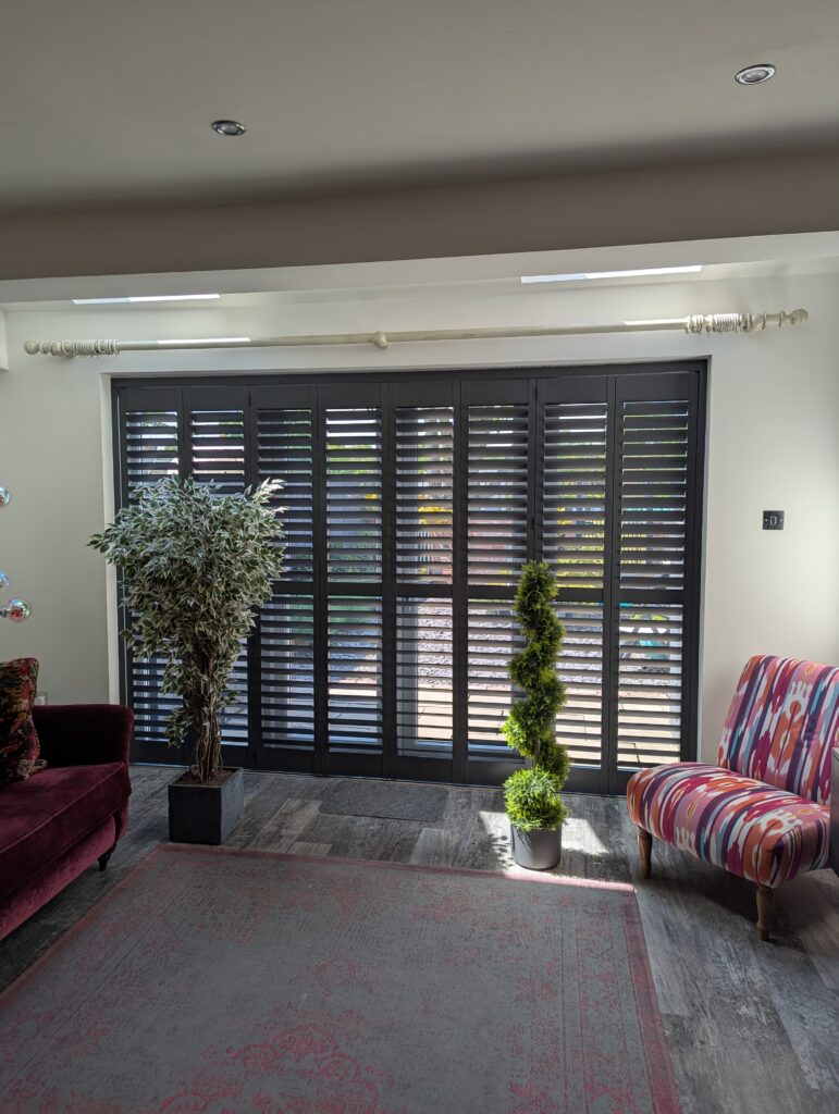 Anthracite Hardwood Shutters Fitted On A Track Over Bi Fold Doors in Wilmslow